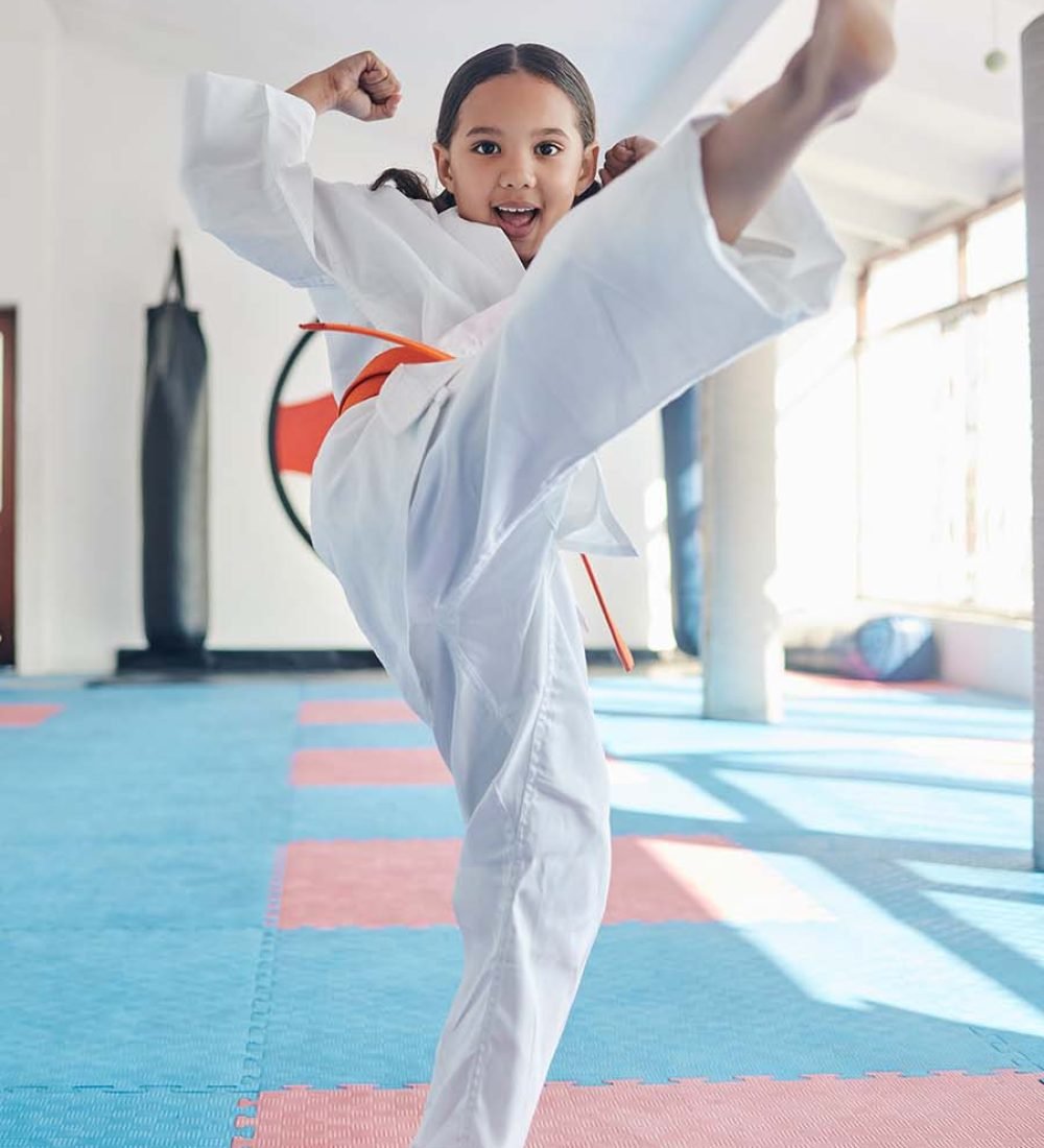 Call me strong before you call me cute. Shot of a cute little girl practicing karate in a studio